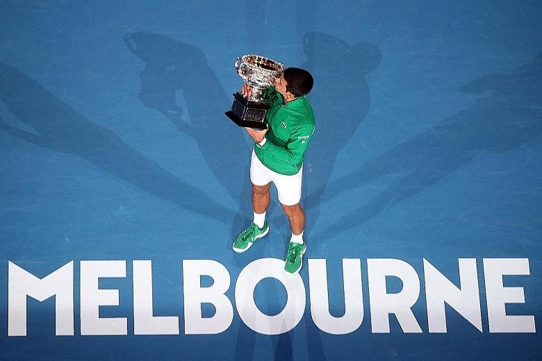 Serbia's Novak Djokovic kissing the trophy after winning the Australian Open final against Dominic Thiem of Austria in February for a 17th Grand Slam title.