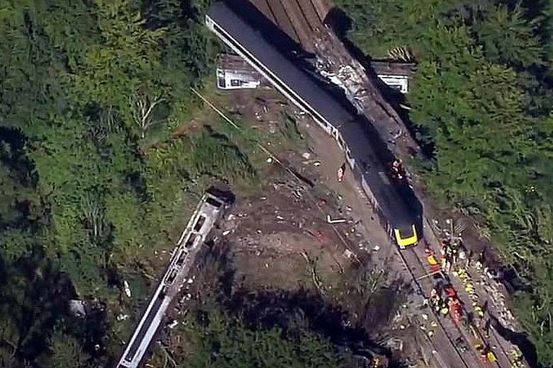 An aerial shot of the woodland area in Scotland with the derailed train yesterday. The incident near Stonehaven, just south of the oil city of Aberdeen, took place after heavy rain overnight. Police said three people died and six were taken to hospit