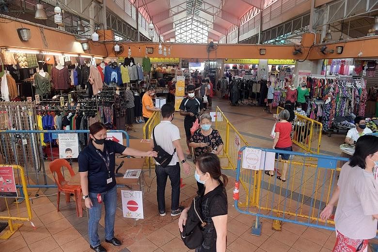 Chong Pang Market at around 10am yesterday. It is one of four markets that had alternate-day entry restrictions on weekdays lifted yesterday, following a noticeable reduction in queues. But the use of SafeEntry for contact tracing and social distanci