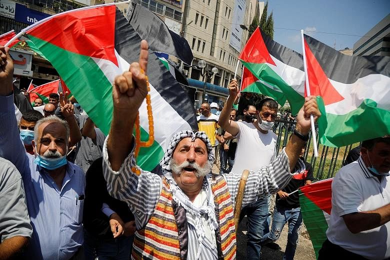 Palestinians protesting against the United Arab Emirates' deal with Israel to normalise relations, in the Israeli-occupied West Bank, yesterday. PHOTO: REUTERS