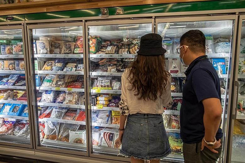 Customers shopping for frozen food at a store specialising in imported goods in Beijing yesterday. China recently reported finding the coronavirus on frozen chicken wings from Brazil, where the pandemic is raging, and on the outer packaging of frozen