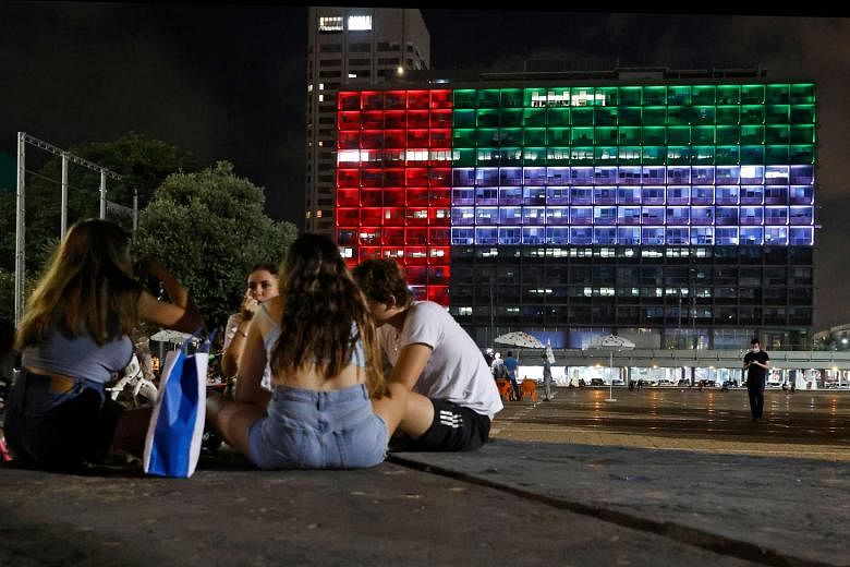 ISRAEL The Tel Aviv City Hall on Thursday, lit up in the colours of the United Arab Emirates flag, after Israel and the UAE reached a deal to normalise diplomatic relations between the two states. US President Donald Trump helped to broker the agreement. 