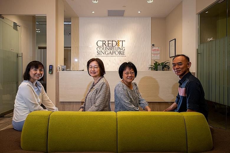 Credit Counselling Singapore (CCS) general manager Tan Huey Min (second from left) with her colleagues (from left) Catherine Siah, Tang Lai Pin and Jonathan Peh. Since 2004, CCS has helped more than 32,000 people manage their finances better. Those w