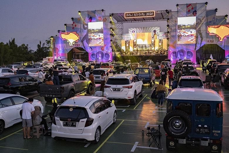 People at a drive-in concert in Ubud, Bali, yesterday. The Indonesian holiday island reopened to domestic tourists on July 31 and the government is considering allowing foreign visitors to enter again.