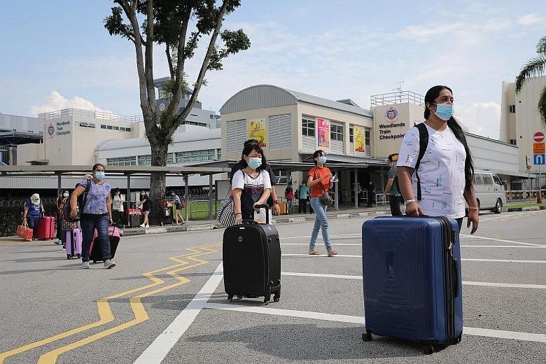 People from Malaysia arriving in Singapore yesterday at the Woodlands Train Checkpoint. As at 10am yesterday, about 300 people had crossed the border in both directions, said a Malaysian official. People arriving in Singapore from Malaysia yesterday,