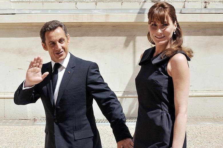 Mr Nicolas Sarkozy and his wife Carla Bruni in Paris on Bastille Day in this July 2008 photograph. He married singer and former model Bruni after a whirlwind romance.