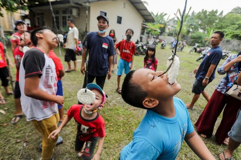 Children in Medan taking part in a cracker eating game yesterday as they celebrated Indonesia's 75th year of independence from former colonial rulers the Netherlands. This year's celebrations were a subdued affair due to the coronavirus pandemic, wit