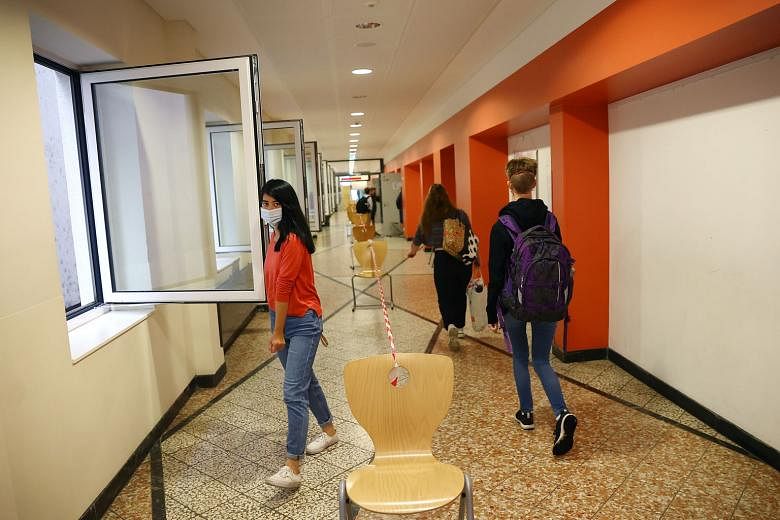 Students practising social distancing at a high school in Germany yesterday, as schools reopened after the summer holidays and a lockdown due to Covid-19. Chancellor Angela Merkel yesterday said there is no scope currently for loosening restrictions.
