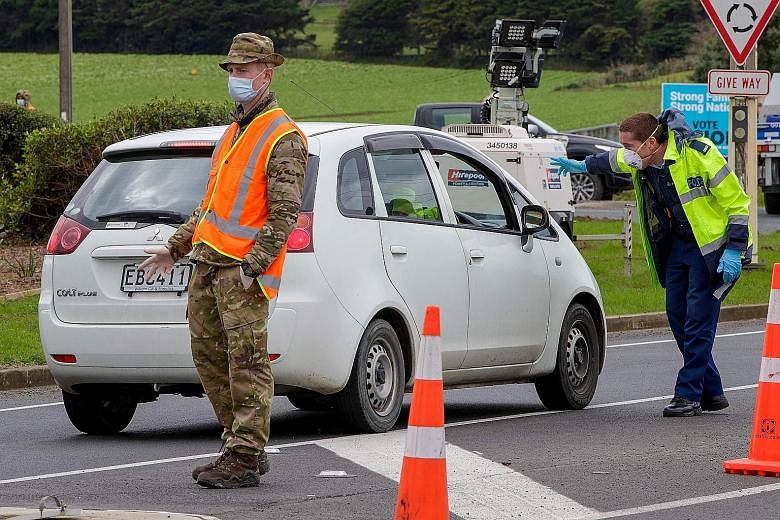 Police and military personnel checking vehicles leaving the city at a check point at the southern boundary in Auckland. The number of defence staff deployed to beat any further spread of Covid-19 will be raised.