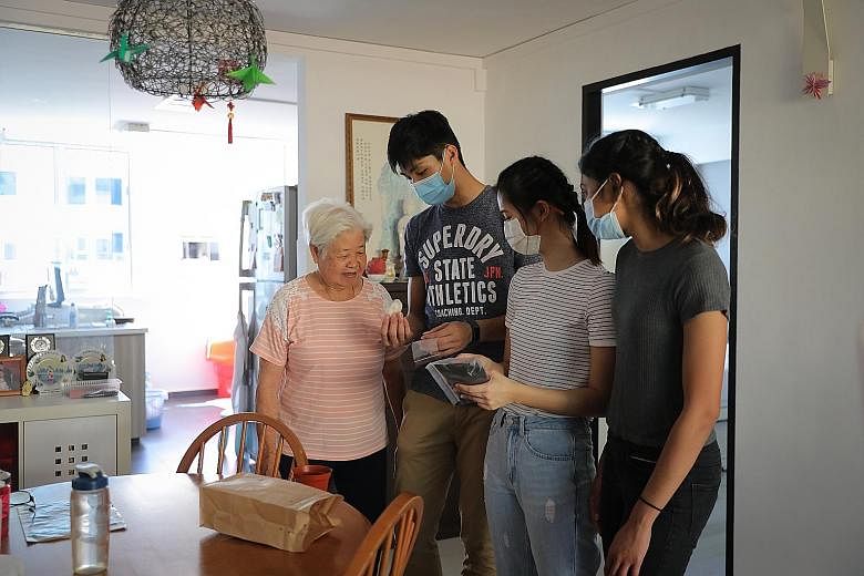 Madam Tay Yoke Mooi, a Fengshan resident, was among the seniors visited on Monday by (from left) junior college graduates Kampton Kam, Maxine Cassandra Lau and Grace Shani Anthony. The three 19-year-olds are working with The Salvation Army on their i