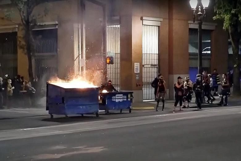The protesters lit fires and used lighter fuel to start a fire inside the Multnomah Building big enough to set off the sprinkler system, the Portland police said. PHOTO: SCREEN GRAB FROM GLOBAL NEWS/YOUTUBE