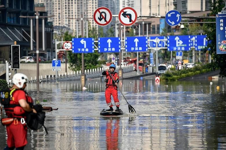 A rescuer paddling across a flooded street in China's south-western city of Chongqing this week. The city has been hit by heavy flooding for the fifth time this year due to heavy rain in the upper Yangtze region. PHOTO: AGENCE FRANCE-PRESSE