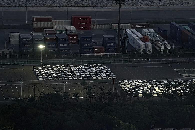 Vehicles bound for shipment near Chiba Port in Japan last Saturday. Data on Monday showed Japan was hit by its biggest economic slump on record in the second quarter as the pandemic crushed demand for cars and other exports, knocking the size of real