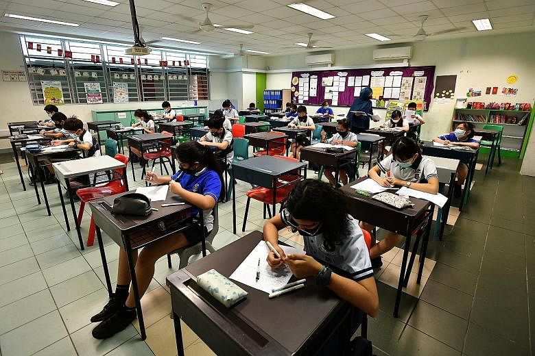 Pupils in a class that practises safe management measures at Jing Shan Primary School on May 27. Safe management measures will continue to be implemented in schools and examination venues during the national examinations. ST PHOTO: LIM YAOHUI