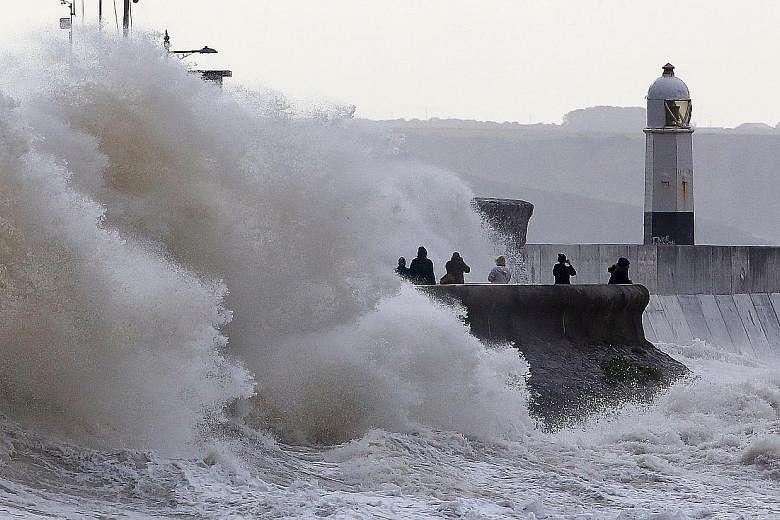Huge waves crashing against the sea wall at Porthcawl, south Wales, yesterday as Storm Ellen brought high winds to Britain and Ireland. Weather warnings were in place across the country, with flood alerts for coastal counties. Transport services were