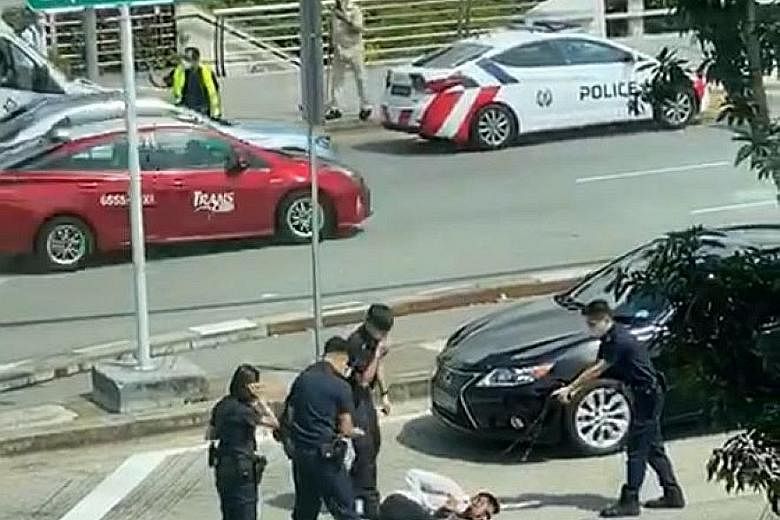 Left, top and left: Police officers attempting to get the man off the road for his own safety but he became belligerent and resisted. He continued to be aggressive, despite repeated reminders to comply with the officers' instructions, and charged at 