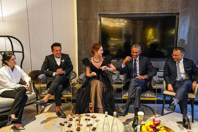 ALLEGEDLY PHOTOSHOPPED: BN Group co-founder Evangeline Shen with Mr Barack Obama at a charity event here last December with the firm's name and logo on the screen, and co-founder Terence Loh to Mr Obama's left. SAID TO BE ORIGINAL: This is believed t