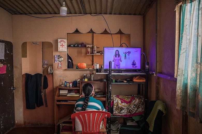 Delia Huamani, 10, watching a TV broadcast of school lessons at her Peru home on Aug 13, with schools closed because of the coronavirus pandemic. Poor regions where the Internet is scarce are turning to older technology to reach children. That strate