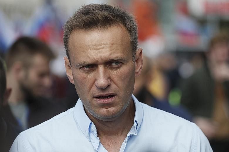 Medical specialists carrying Russian opposition leader Alexei Navalny, 44, on a stretcher into an ambulance in the Siberian city of Omsk on their way to an airport, before his medical evacuation to Berlin yesterday. He had collapsed on a plane last T