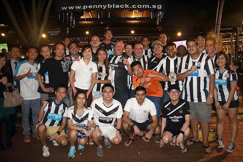 David Alexander (front row, far left) with fellow members of Newcastle United Supporters Club Singapore gathering to watch a match at Boat Quay. PHOTO COURTESY OF DAVID ALEXANDER