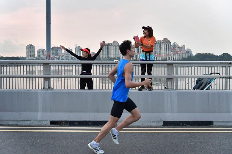 Supporters cheering ST Run participants on the Merdeka Bridge last September. To mark this newspaper's 175th anniversary, there will be two categories at The Straits Times Virtual Run - 17.5km and 175km.