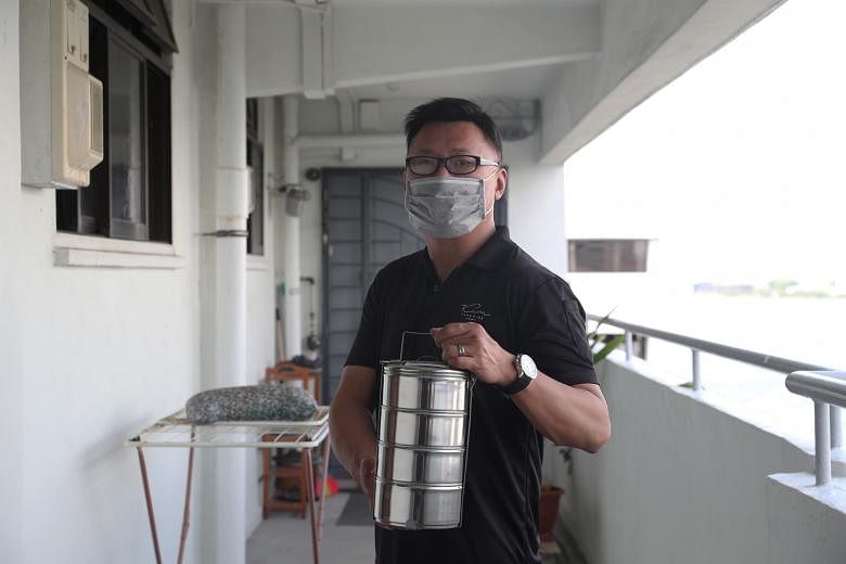 Above and left: Kim Paradise managing director Clement Tiang making tingkat deliveries. Even though the tingkat side is doing well, bookings for catering are down almost 90 per cent for his company.