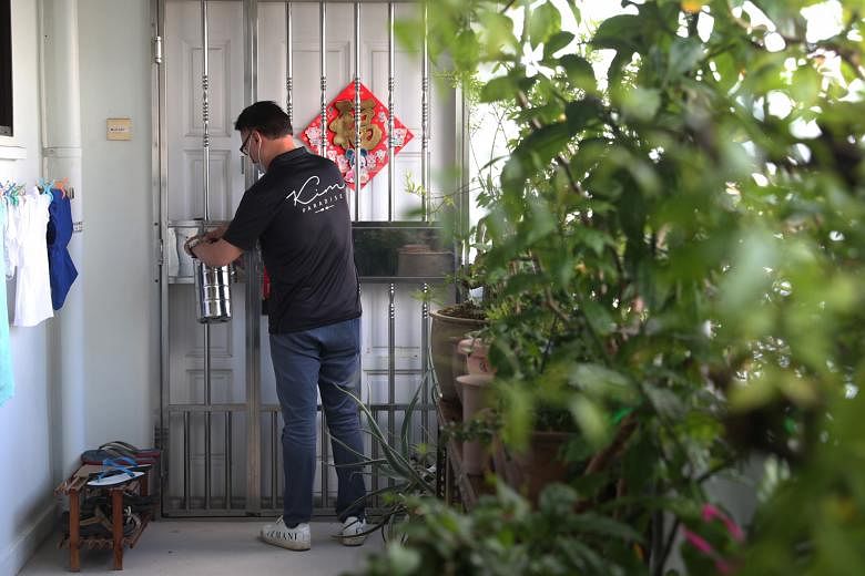 Above and left: Kim Paradise managing director Clement Tiang making tingkat deliveries. Even though the tingkat side is doing well, bookings for catering are down almost 90 per cent for his company.