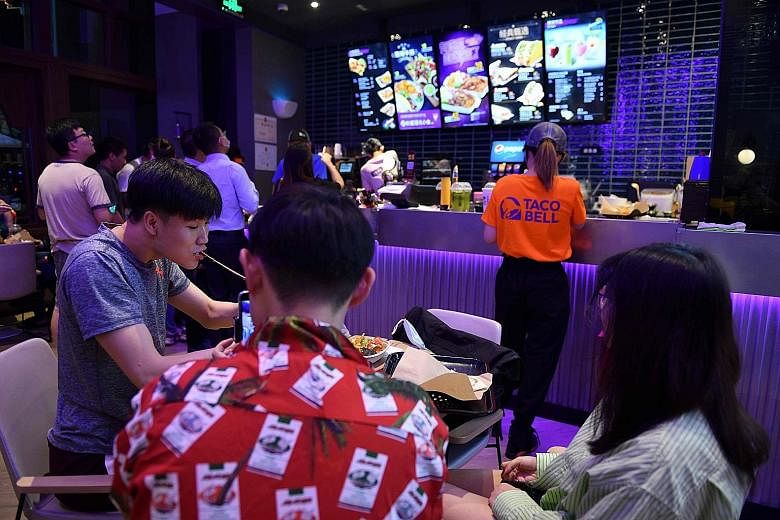 Customers at a newly opened Taco Bell outlet in Beijing last week. Despite a delayed response and early missteps by the government, the recovery in China points to the success of its extreme tactics such as sweeping lockdowns. After months of travel 