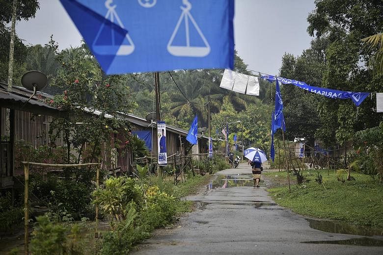 Flags and buntings in an Orang Asli village during the Slim by-election in Perak. Campaigning seemed lacklustre on the whole.