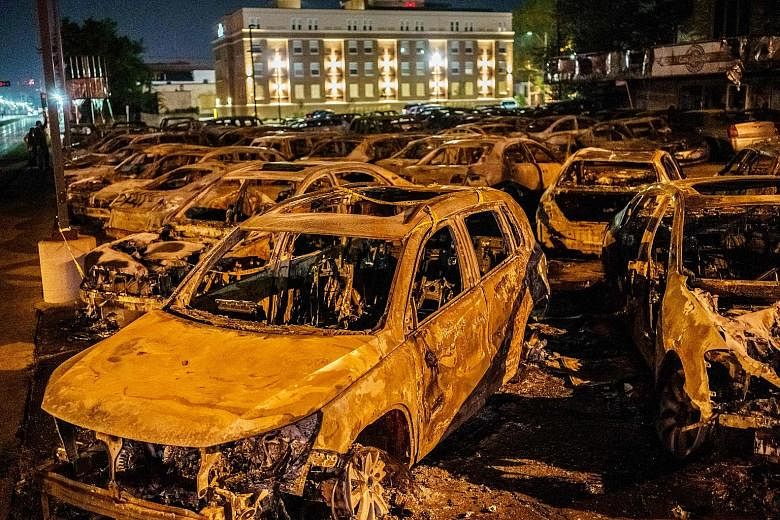 Burnt cars at a used-car lot in Kenosha after a protest on Tuesday. The police shooting has sparked three nights of civil unrest including arson and vandalism.