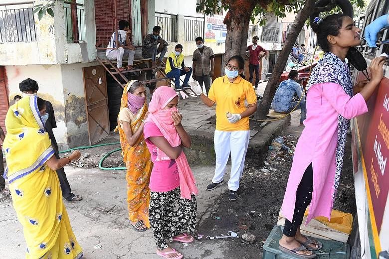 People queueing up for a Covid-19 swab test in New Delhi yesterday. India confirmed 75,760 new infections yesterday, taking its total coronavirus tally to over 3.3 million cases. PHOTO: EPA-EFE