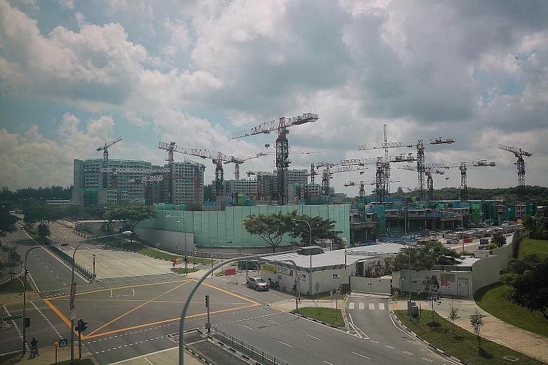 The construction site of the Waterway Sunrise II project (front) in Punggol yesterday. Launched in February 2017, the project has 1,014 units in seven blocks and is currently about 45 per cent completed. ST PHOTO: JASON QUAH
