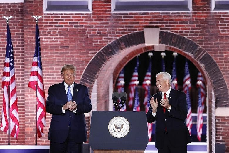 US President Donald Trump on stage with Vice-President Mike Pence after Mr Pence's speech at Fort McHenry in Baltimore, Maryland, on Wednesday. Mr Trump's arrival was met with chants of "four more years" from the crowd.