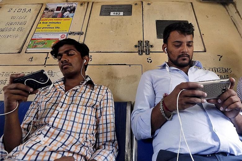 Commuters on a Mumbai suburban train. India's telecom industry has over the past two decades transformed the lives of millions of Indians to the point where even the poor can afford a phone and a connection. But many companies, ridden by debt and tou