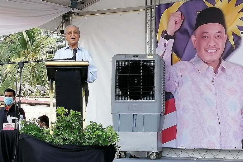 Tun Dr Mahathir Mohamad speaking at a rally in Slim River, Perak, yesterday. He was campaigning for Islamic lawyer Amir Kusyairi Mohd Tanusi, the Parti Pejuang Tanah Air candidate in tomorrow's by-election. ST PHOTO: HAZLIN HASSAN