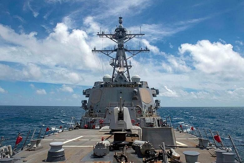 The comments against the United States by a Chinese Foreign Ministry spokesman yesterday came after the US' guided missile destroyer USS Mustin (above) carried out a freedom of navigation operation near the Paracel Islands, where the People's Liberat