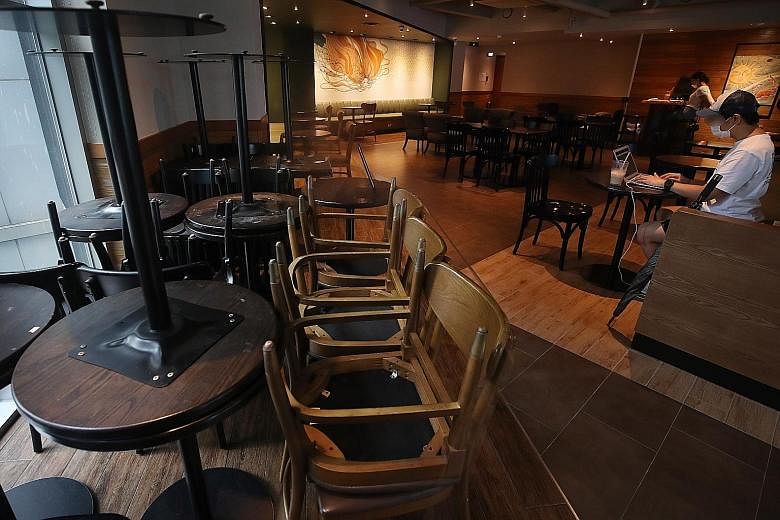 Tables and chairs stacked in a corner of a large cafe in downtown Seoul yesterday, as cafes and other food and beverage outlets readied themselves to comply with stricter rules to prevent the spread of the coronavirus, including restricting coffee sh