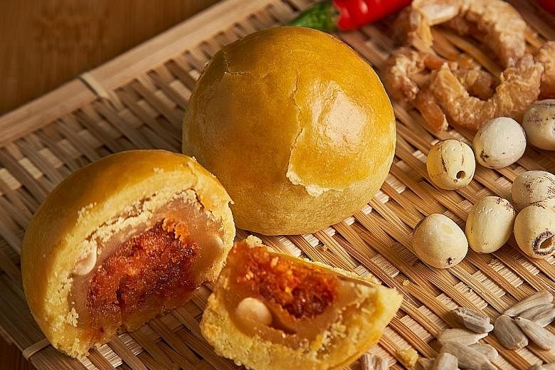 Above: Now Bakery's Shanghai mooncake filled with homemade sambal dry shrimp. Right: The Capitol Kempinski Hotel Singapore's mini mooncakes, presented in a jewellery box, with a range of six snowskin and four baked offerings. SPH subscribers will hav