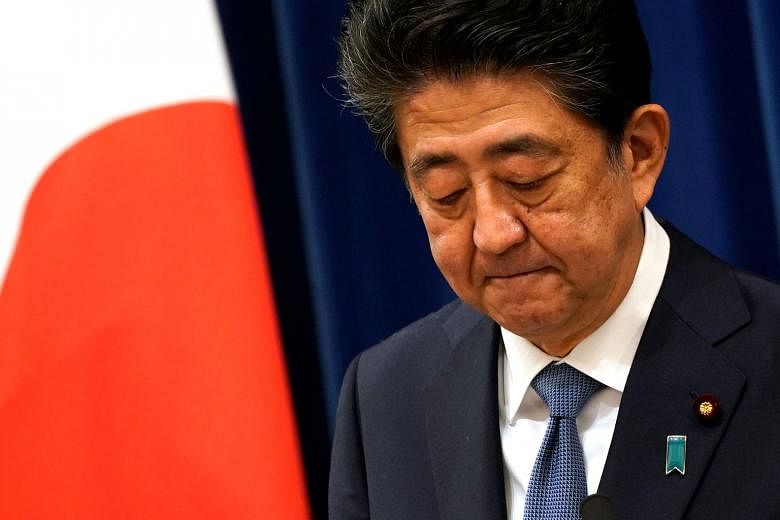 Japanese Prime Minister Shinzo Abe at a news conference in Tokyo yesterday, when he said he found it painful to quit during the Covid-19 crisis, and before achieving his goals.