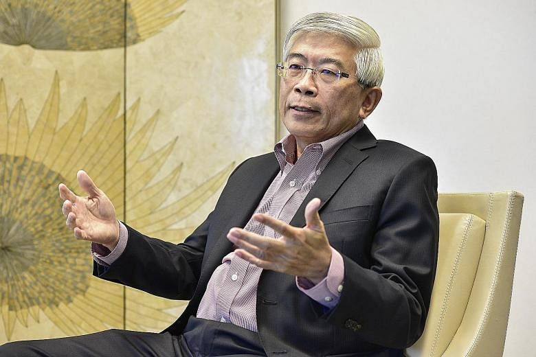 ExxonMobil's refinery in Jurong (left). ExxonMobil Asia-Pacific chairman and managing director Gan Seow Kee (above) says the company's philosophy is to hire locally and provide its staff a broad range of experiences. Advanced MedTech staff at its Tua