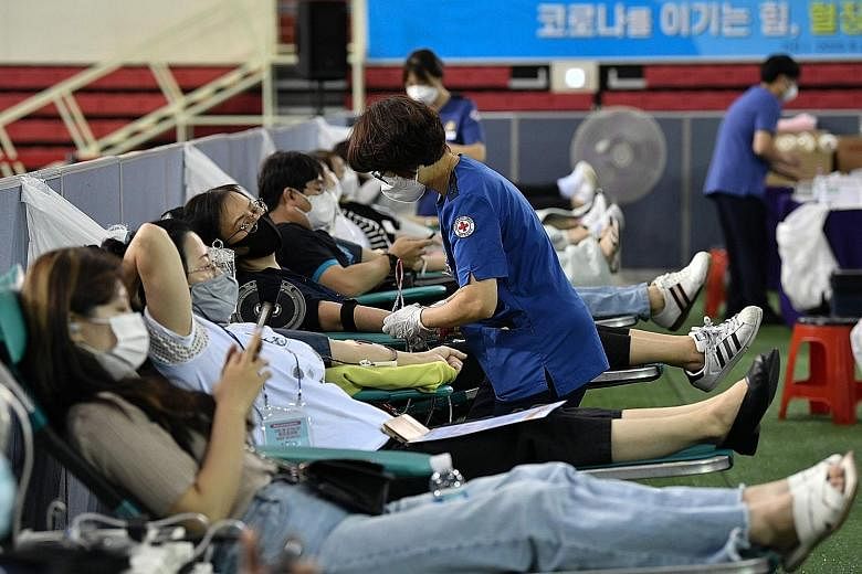 Members of the Shincheonji Church of Jesus who have recovered from the Covid-19 coronavirus donating their blood plasma at a gymnasium in Daegu last Friday. The secretive South Korean sect linked to more than 5,000 virus cases in the country has apol