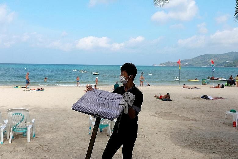 A waiter at a beach resort in Phuket. Thailand is planning to grant visas for up to nine months to foreigners and seniors to escape winter in their own countries, said Mr Boon Vanasin, chairman of Thonburi Healthcare Group. PHOTO: REUTERS