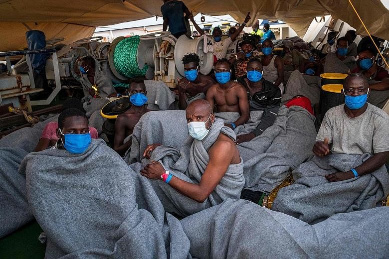 Migrants on board the humanitarian rescue vessel Sea-Watch 4 off the coast of Malta on Saturday. They had just been transferred to the ship from a rescue ship funded by British street artist Banksy.