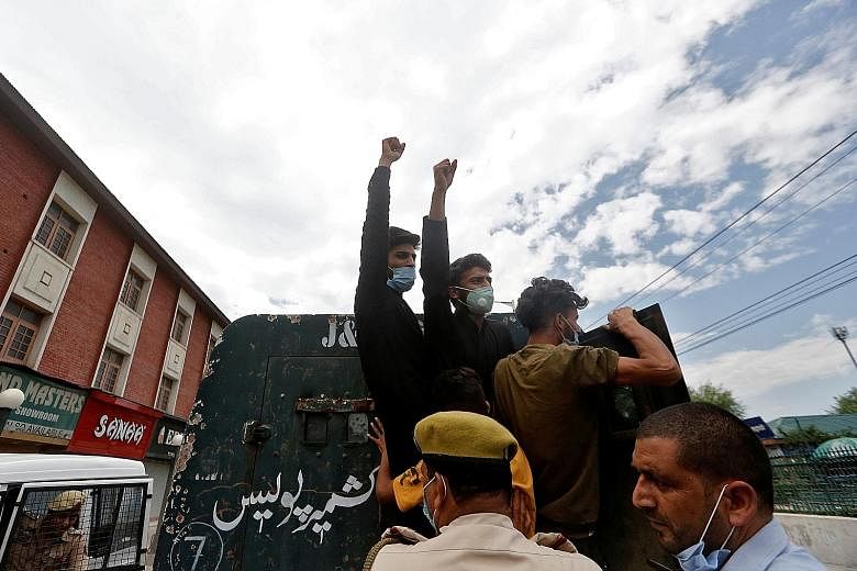 Kashmiri Shi'ite Muslims shouting slogans as they were detained by police during a protest yesterday. The Indian authorities had reimposed a ban on religious gatherings last Thursday after clashes with Shi'ite Muslims wanting to stage traditional pro