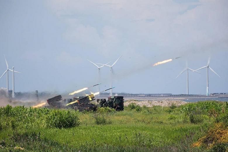 Rockets (above) being launched from a domestically manufactured multiple rocket system and two US-made AH-64E attack helicopters (left) releasing flares during a Taiwanese military drill in Taichung last month. The exercises aimed to demonstrate how 