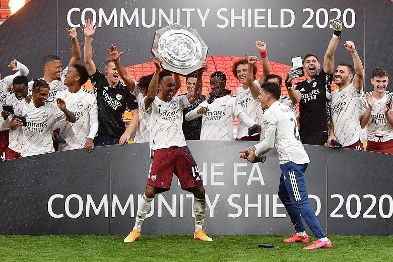 Arsenal captain Pierre-Emerick Aubameyang lifting the Community Shield, after defeating Liverpool on penalties. The Gabon forward has kept Arsenal waiting nervously during protracted talks over his new contract. PHOTO: REUTERS