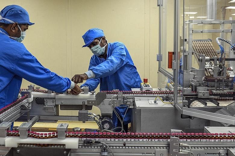 Workers at an assembly line last month at Pune's Serum Institute of India, the world's largest manufacturer of vaccines by volume. It has secured a manufacturing contract for two leading Covid-19 vaccine candidates, from AstraZeneca and Novavax. PHOT