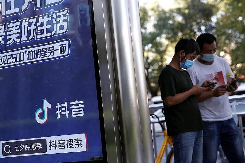 An advertisement for Douyin, as TikTok is known in China, at a bus stop in Beijing. The country's latest export curbs ensnare TikTok and potential US buyers including Microsoft and Oracle. PHOTO: REUTERS