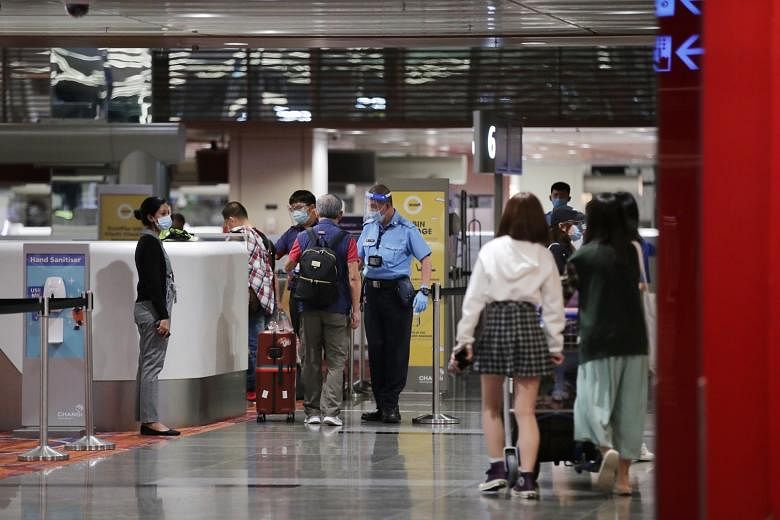Passengers checking in for Scoot Flight TR100 to Guangzhou early yesterday morning at Changi Airport Terminal 1. Despite a rush for Covid-19 tests after the Chinese Embassy announced new rules on Aug 21, requiring travellers from Singapore to China t
