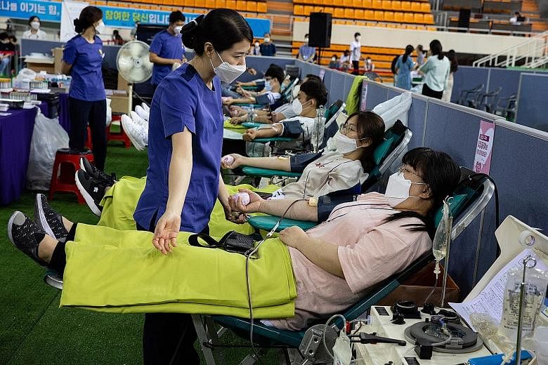 Recovered members of the Shincheonji Church of Jesus donating blood plasma yesterday in Daegu, South Korea, for the development of a new medicine.